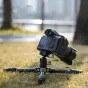 Fotopro P-2 Mini carbon fiber mini tripod with P-2H ball head, compact 3‑section design on grass with a Sony camera attached, highlighting lightweight travel capability