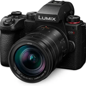 Panasonic LUMIX G9 II mirrorless camera with Leica 12-60mm f/2.8-4.0 lens, featuring textured grip, multiple control dials, and red-ring mode dial, presented against a plain white background.