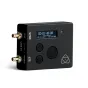 Atomos AtomX Ultrasync One wireless timecode transmitter featuring an OLED display showing '00:01:45:08', dual BNC connectors labeled 'IN/OUT' and 'USB 5V', and controls including a circular button and downward arrows.