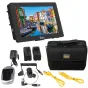 Ikan Saga 7 High Bright Monitor Deluxe Kit displaying a colorful canal scene with boats and buildings, includes battery plates, coiled HDMI cable, right-angle SDI cable, P-TAP to Mini-XLR audio cable, DV battery charger, and two