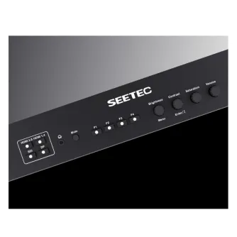 Close-up of a Feelworld Seetec 21.5" 4K Broadcast Monitor featuring front panel controls, HDMI and 3G-SDI ports, and LED tally indicators, mounted on a metal case with a V-mount plate.