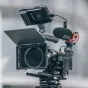 Falcam F22/F38/F50 horizontal-to-vertical quick-release circular half cage on a camera, featuring a top carbon-fiber plate, side handle, and mounted Rode microphone with a windscreen, ideal for rapid mode switching.