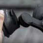 Close-up of the PGYTECH CapLock suction cup base with adjustable ball joint, hand holding it and a blue rotation arrow.