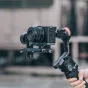 Falcam F22 Quick Release Bottom Plate for Sony A7C mounted on a gimbal stabilizer with a circular half cage and wrist strap holes