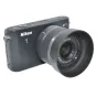 Nikon J1 camera with JJC HN-N101 sun hood attached, front view, compatible with Nikon 10mm f/2.8 Solo lens