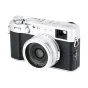 Silver JJC LH-JX100VII lens hood with adapter ring attached to a Fujifilm X100 series compact camera, showcasing the matte aluminum sunshade protecting the lens.