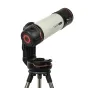 Celestron Origin Intelligent Home Observatory, установленная на штативе, с белым цилиндрическим корпусом и черными акцентами, с красным подсвеченным элементом спереди.