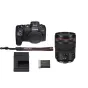 Canon EOS R8 mirrorless camera body with RF 24-105mm f/4L lens, black strap, charger and battery, complete bundle on white background