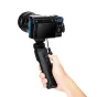 JJC TP PA2 Shooting Grip attached to a Panasonic Lumix camera, featuring integrated controls for shutter and video recording, positioned vertically with a thumbwheel for mounting and a cable connection.