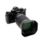 Nikon Z 28-400mm f/4.8 VR lens with JJC LH HB114 lens hood attached, protecting against stray light and impacts, featuring a matte non-reflective finish