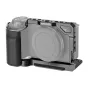 Neewer CA003S aluminum camera cage for Sony ZV-E10 featuring a rubber grip handle and Arca-Swiss base for stable tripod or gimbal mounting.