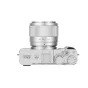 Объектив Viltrox AF 56мм F1.7 Fuji X серебристый на корпусе камеры Fujifilm X-E5, вид сверху с кольцами фокусировки и диафрагмы