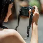 Falcam Maglink Quick Magnetic Buckle Shoulder Strap Lite V2 in use with a compact camera, showcasing the magnetic buckle and sleek black strap design.