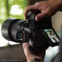 Westcott FJ T1 M wireless trigger with OLED touchscreen in use, attached to a DSLR camera for professional flash control