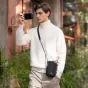 PGYTECH OneGo Casual Crossbody Mobile Bag in Space Black with lens cleaning cloth on strap, ideal for street photographers and mobile creators