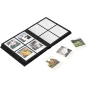 Polaroid Studio Coffee Table Photo Album with an open black cover displaying a grid of filled photo slots and scattered Polaroid prints nearby
