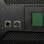 Задняя панель студийного LED-светильника Ikan Lyra 1x1 Bi-Color с разъемами DMX512 In/Out и подсвеченной панелью управления с зеленым дисплеем.