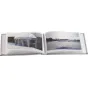 FOCUS Ritz Pocket 40 beige textured photo album open with winter-themed photos showcasing snowy rooftop icicles and a frozen lake landscape