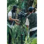 Аккумулятор SmallRig T99 V-Mount в работе с профессиональной кинокамерой на штативе, полевое использование, подчеркивающее прочный алюминиевый и TPU корпус.