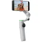 Insta360 Flow 2 Pro AI stabilizer with magnetic phone clamp capturing smooth video of a person and dog at the beach, showcasing AI tracking in action