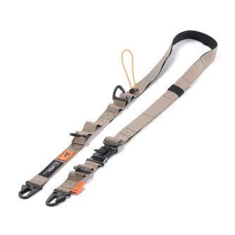 Tilta Fe multi-functional shoulder strap featuring durable beige polyester webbing with black and orange accents, adjustable carabiners, and a dual drawstring lock system for secure attachment of camera gear and accessories.