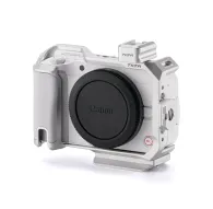 Tilta Full Camera Cage for Canon R50 V - silver side view featuring cold shoe, NATO rail, and ergonomic grip for professional photographyTilta Full Camera Cage for Canon R50 V - silver side view featuring cold shoe, NATO rail, and ergonomic grip for professional photography