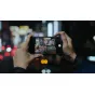Tilta Khronos iPhone 16 Pro handheld kit with focus handle and filter tray in use, showcasing nighttime cityscape photography for mobile filmmaking