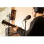 Zoom UAC-232 USB audio converter with guitar input, recording setup featuring a tablet monitor and professional over-ear headphones for high-quality 32-bit float audio conversion