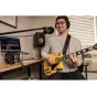 Zoom UAC-232 USB audio converter in a professional home studio setup with a yellow electric guitar, headphones, and audio software displayed on a laptop.
