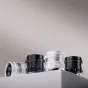 Thypoch Simera 35mm f1.4 lens set in black and silver finishes, showcasing front view with aperture and focus rings, depth-of-field scales, and included lens hoods.