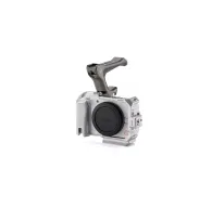 Tilta sudraba kameras korpuss Canon R50 V ar noņemamu NATO virsotni un ARCA plāksni, priekšējais skats, kas parāda integrētu ergonomisku rokturi un objektīva nodalījumuTilta sudraba kameras korpuss Canon R50 V ar noņemamu NATO virsotni un ARCA plāksni, priekšējais skats, kas parāda integrētu ergonomisku rokturi un objektīva nodalījumu