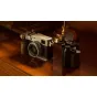 Tilta Vintage Camera Cage for Fujifilm X100VI with walnut wooden handgrip and Arca adapter, enhancing grip and stability for travel photography