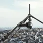 Ulanzi 1.8m lightweight mirrorless tripod with extended height, supporting a mirrorless camera on rocky terrain near water