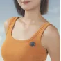 Ulanzi A21 wireless lavalier microphone transmitter clipped on an orange sleeveless top, featuring a compact black design with a green LED indicator.