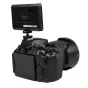 Ulanzi VL120 RGB LED video light mounted on DSLR camera with cold shoe adapter, displaying OLED screen and color options