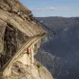 Professional VariZoom VZSNAPCRANE12 4-meter camera crane jib in action, demonstrating long reach and stability for aerial filming in rugged outdoor environments