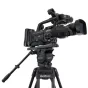 VariZoom VZTKC100C professional video tripod with FH100 fluid head and carbon fiber legs, featuring telescoping pan handle and claw-spike feet for stable camera support up to 22 lbs