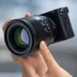 Viltrox AF 56mm f/1.2 E ultra-fast portrait lens for Sony E-Mount with sharp optics and stunning bokeh, shown in close-up with attached lens hood and camera body