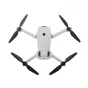 Top-down view of DJI Lito 1 drone with extended black propellers in cross formation, lightweight white body featuring a central camera and DJI branding, designed for portability with orange-tipped propellers for visibility.