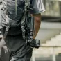 SmallRig VT-15 Mantis Tripod attached to vest for mobile vlogging and action camera stabilization, featuring extendable arm and carabiner hook for versatile shooting angles