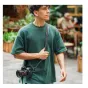 Falcam Maglink Quick Magnetic Buckle Shoulder Strap Classic V2 in black with magnetic quick-release system, worn around the neck and shoulder for comfortable DSLR camera carrying