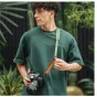 Falcam Maglink Quick Magnetic Buckle Shoulder Strap Classic V2 in green with DSLR camera, showcasing magnetic quick-release buckle and leather shoulder pad for comfortable crossbody photography use