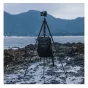 FALCAM TreeRoot Quick Lock Travel Tripod set up on a rocky shoreline with a DSLR camera mounted, featuring twist-lock carbon fiber legs and rubber feet for stability in rugged environments.