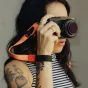 Peak Design Cuff wrist strap with magnetic clasp attached to Fujifilm camera, featuring a red accent detail.