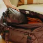 Peak Design Packing Cube Small in eclipse color, open to reveal dual compartments and internal divider, featuring an ultra-fast tear-away zipper for easy access.