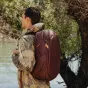 Peak Design Travel Backpack 30L Eclipse in use, stylish brown backpack with waterproof bottom and magnetic strap flaps for secure travel and everyday carry