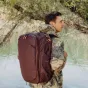 Peak Design Travel Backpack 45L Eclipse worn by a traveler outdoors, featuring side access points and expandable storage.