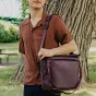 Peak Design Everyday Tote V2 15L maroon bag with magnetic clasp closure, showcasing padded shoulder strap and open interior organization in outdoor park setting