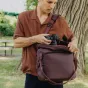 Peak Design Everyday Tote V2 15L open bag with DSLR camera inside, showcasing magnetic clasp closure and padded shoulder strap