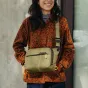 Peak Design Everyday Sling V2 3L kelp green crossbody bag with adjustable padded strap, minimalist design for everyday carry or photo gear